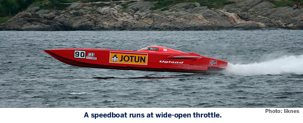 A speedboat runs at wide-open throttle.