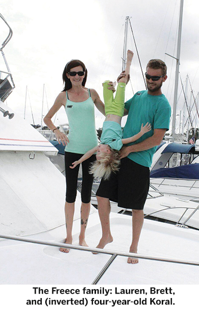 The Freece family: Lauren, Brett, and (inverted) four-year-old Koral.
