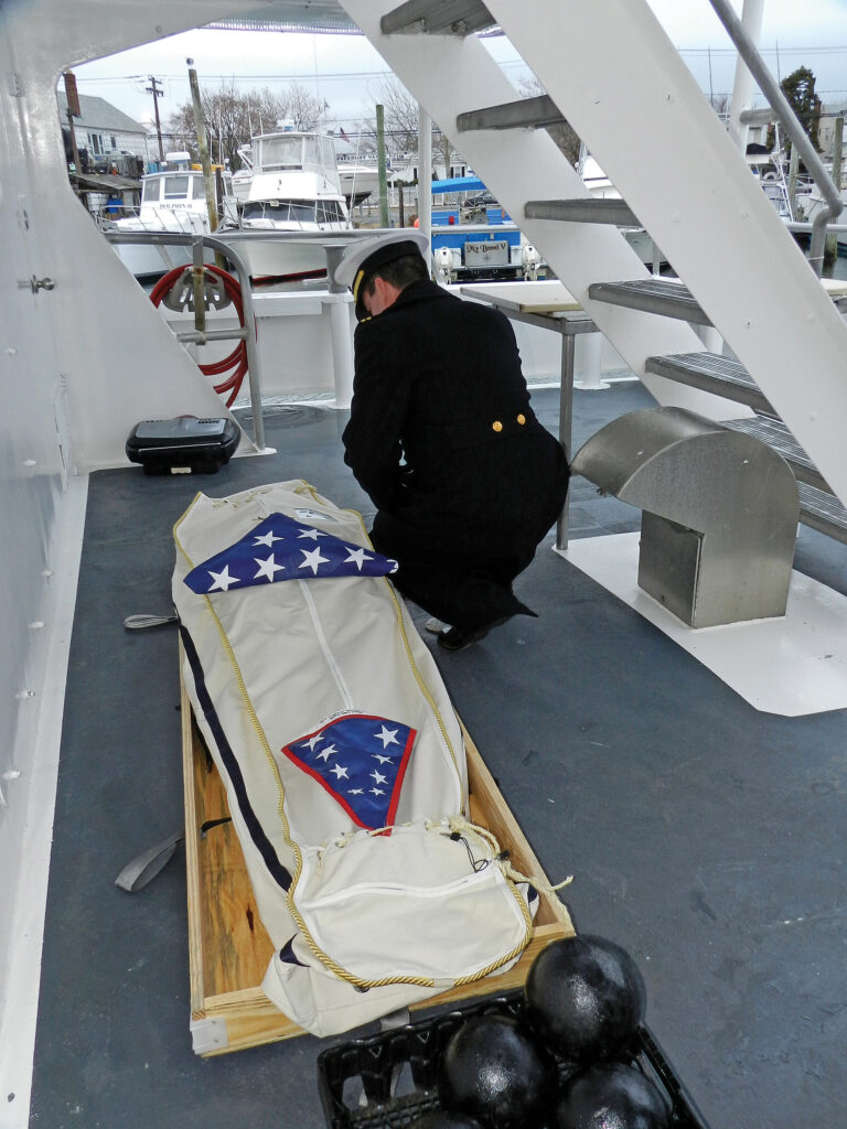 a man kneeling next to a coffin
