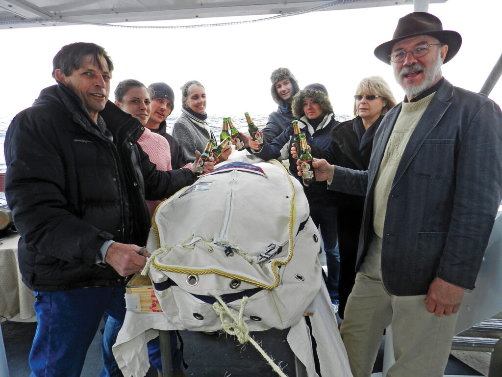 a group of people holding bottles of beer
