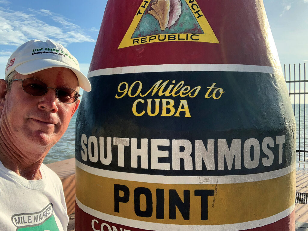 a man standing next to a sign