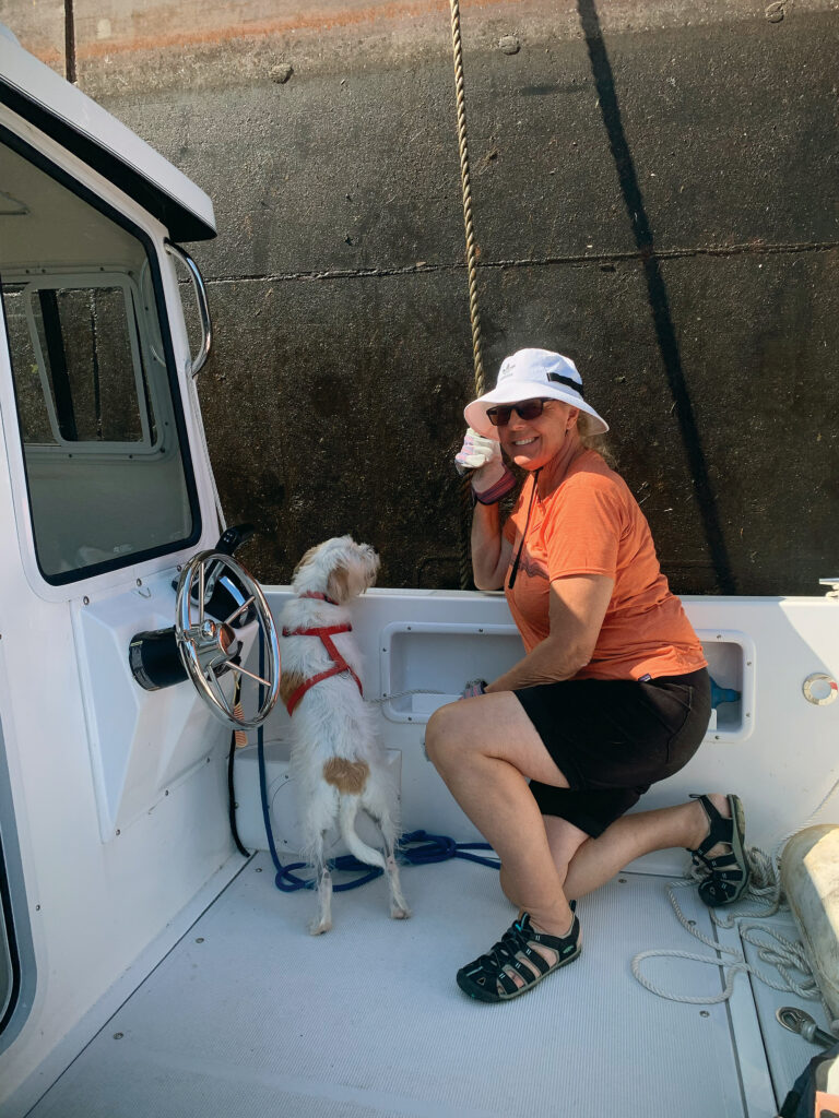 A woman and a dog on a boat