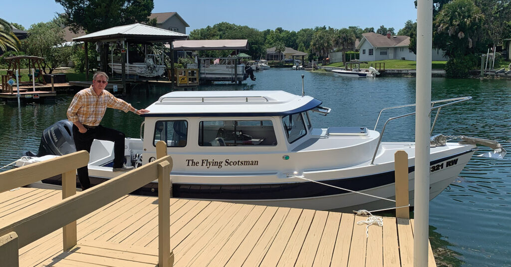 a man standing next to a boat