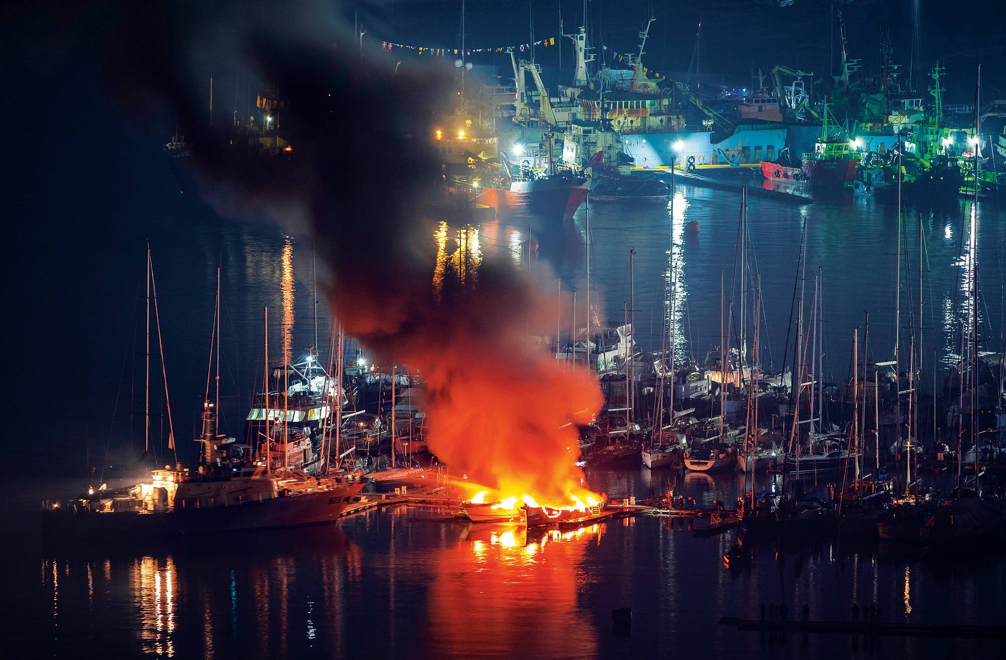 During the night, firefighters try to put out two luxury yachts Boat on fire in Ft Lauderdale marina
