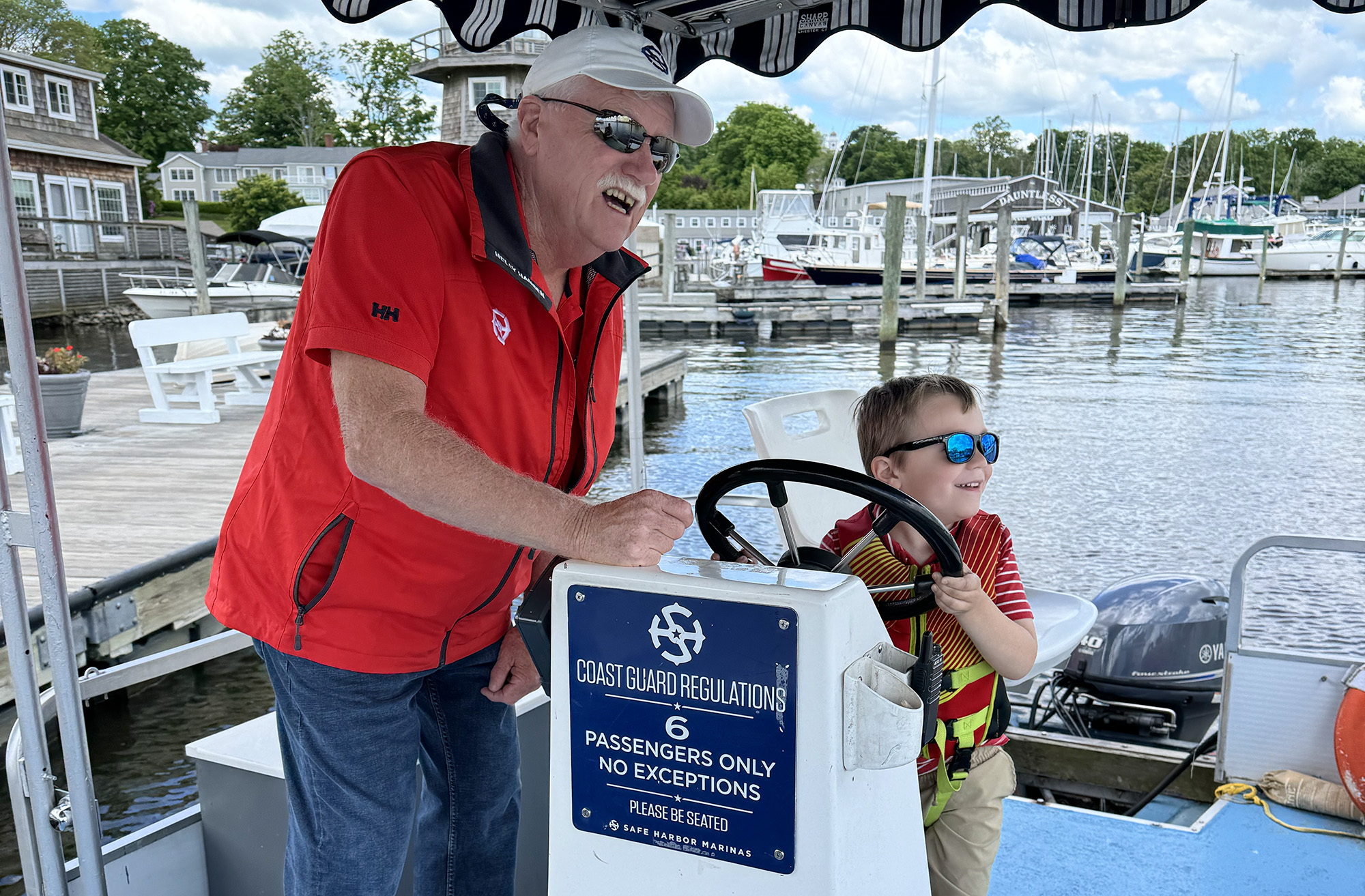 featured_capt_connor A little boy driving a boat