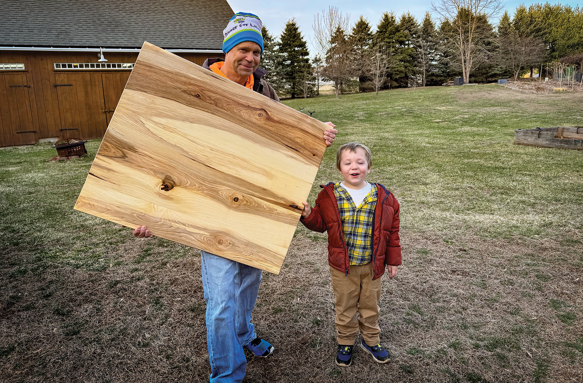 feat-table-talk Dan’s friend and son stand proudly with the hand-made salon table.