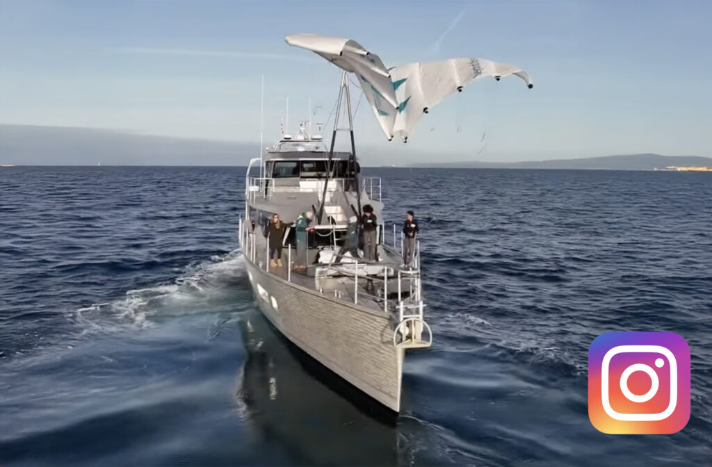 boat with kite flying off its bow