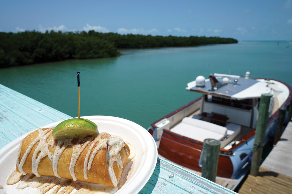 Key lime pie with docked boat in the background.