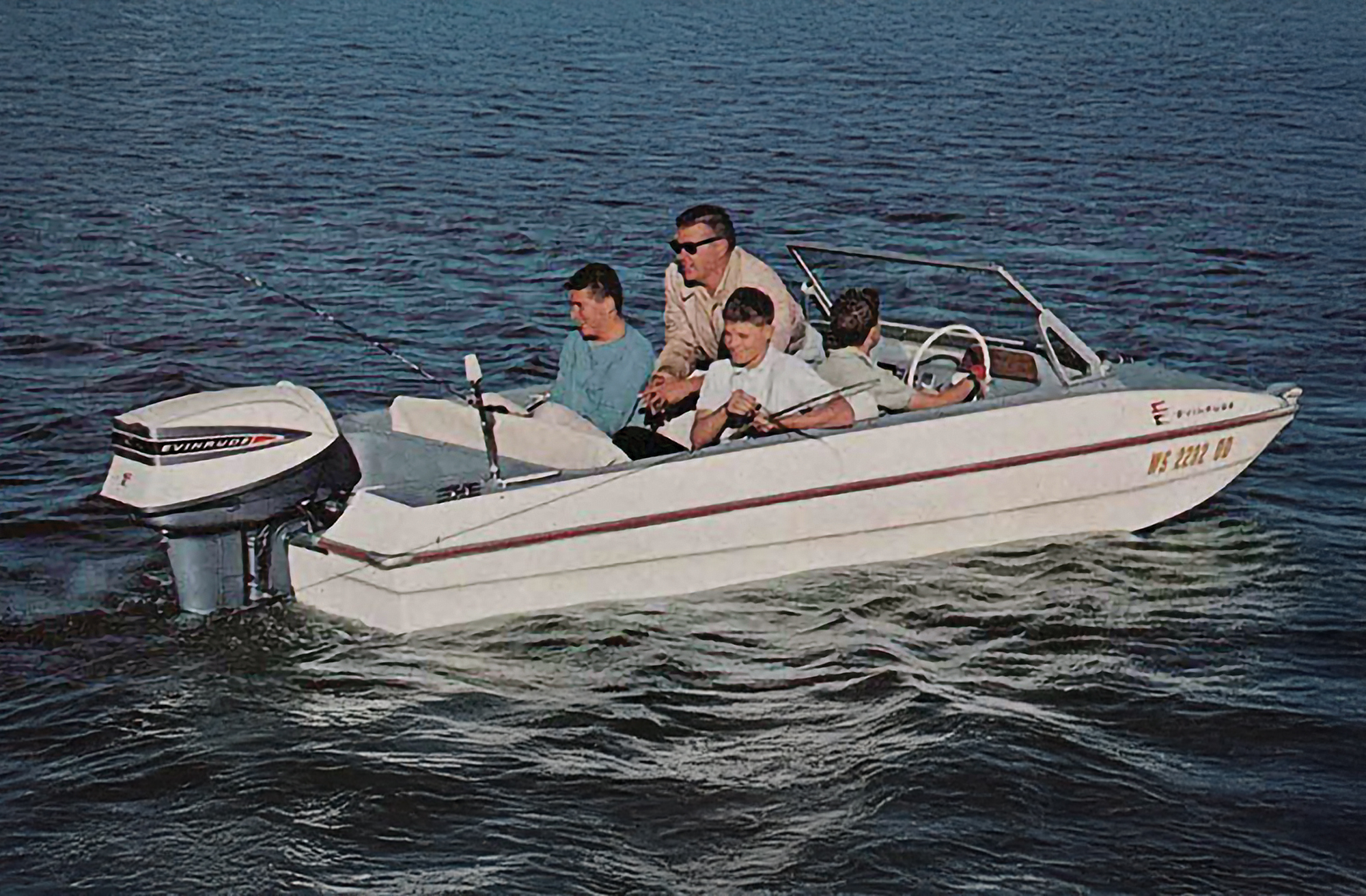 feat_EvinrudeSkiFishBoat Small outboard boat with family fishing from it.