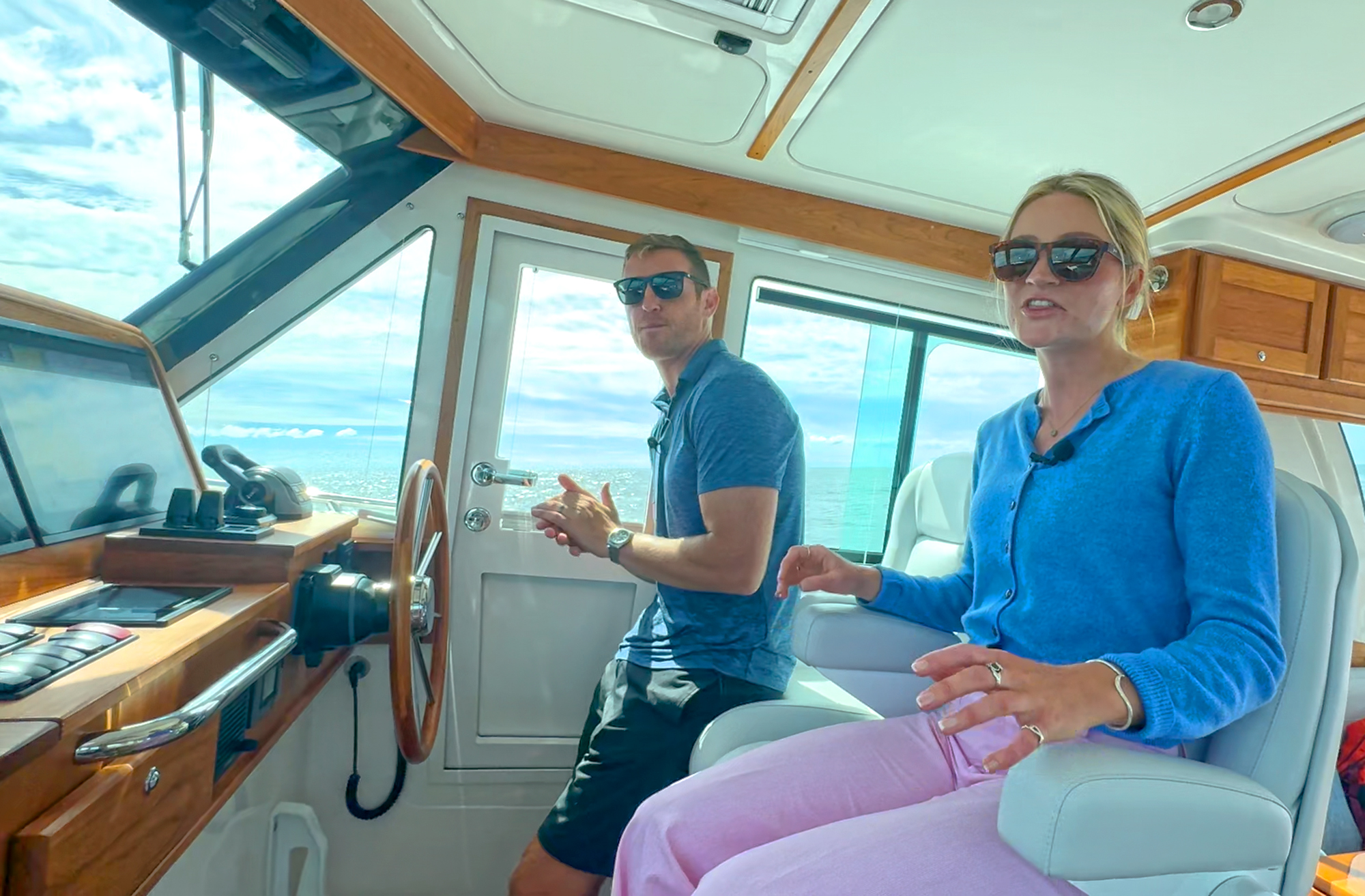 A man and a women at a yacht's helm