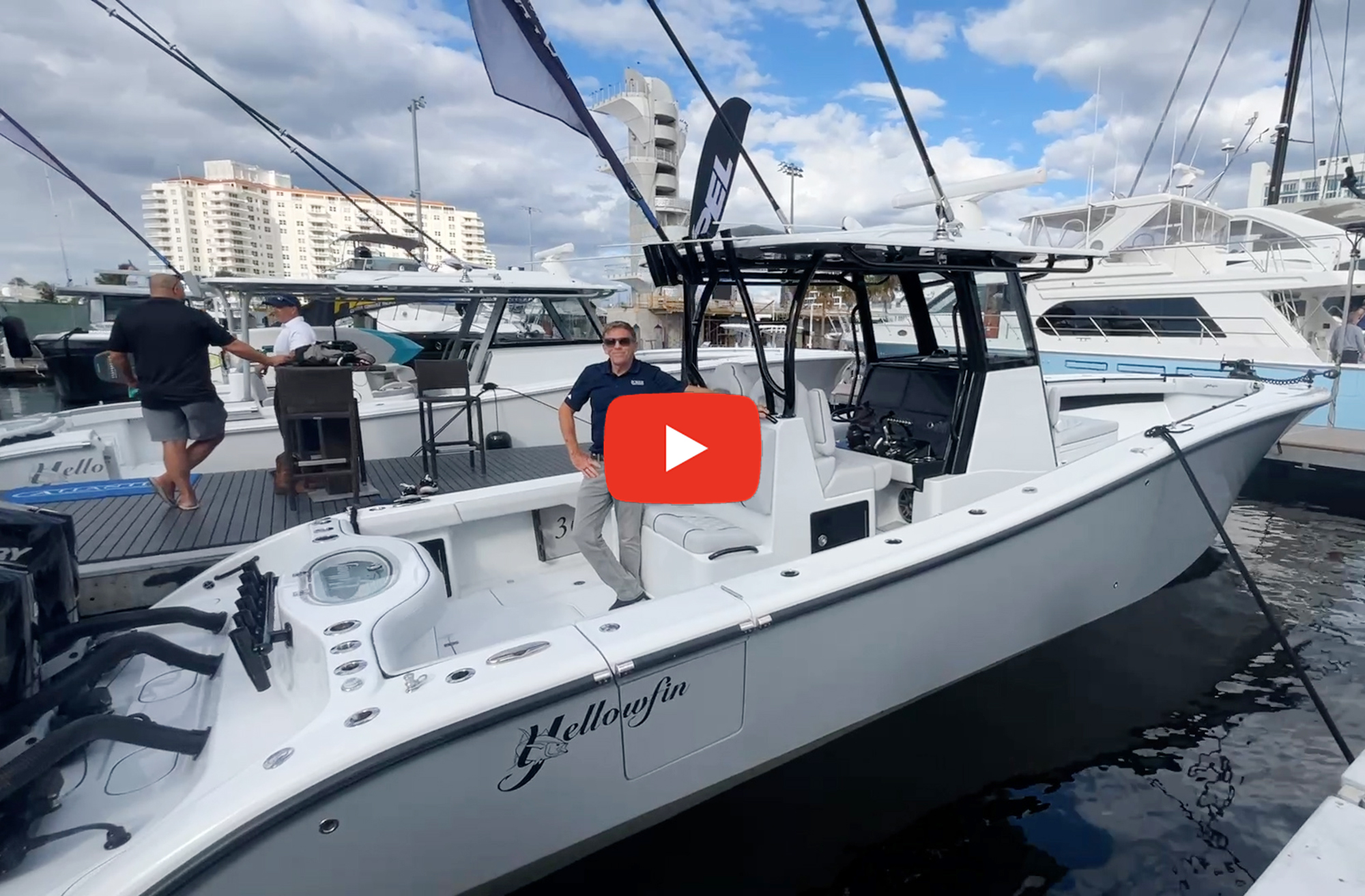 feat_Yellowfin-36 Center console boat at a dock with a man posing in it