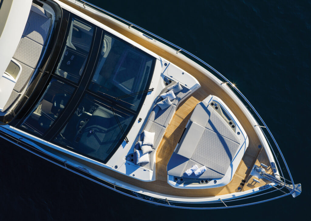 Seating area in bow of a luxury yacht seen from above.