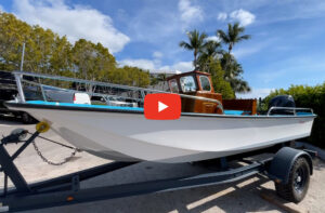 17-foot Boston Whaler on a trailer with palm trees in the background