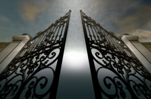A set of ornate gates opening under an ethereal light