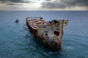The infamous Sapona concrete ship sits wrecked in the shallow water