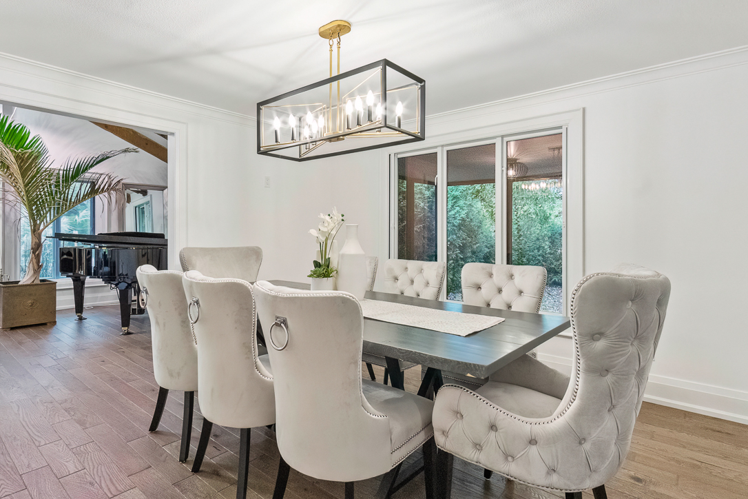 Elegant dining room with a large table and tufted chairs