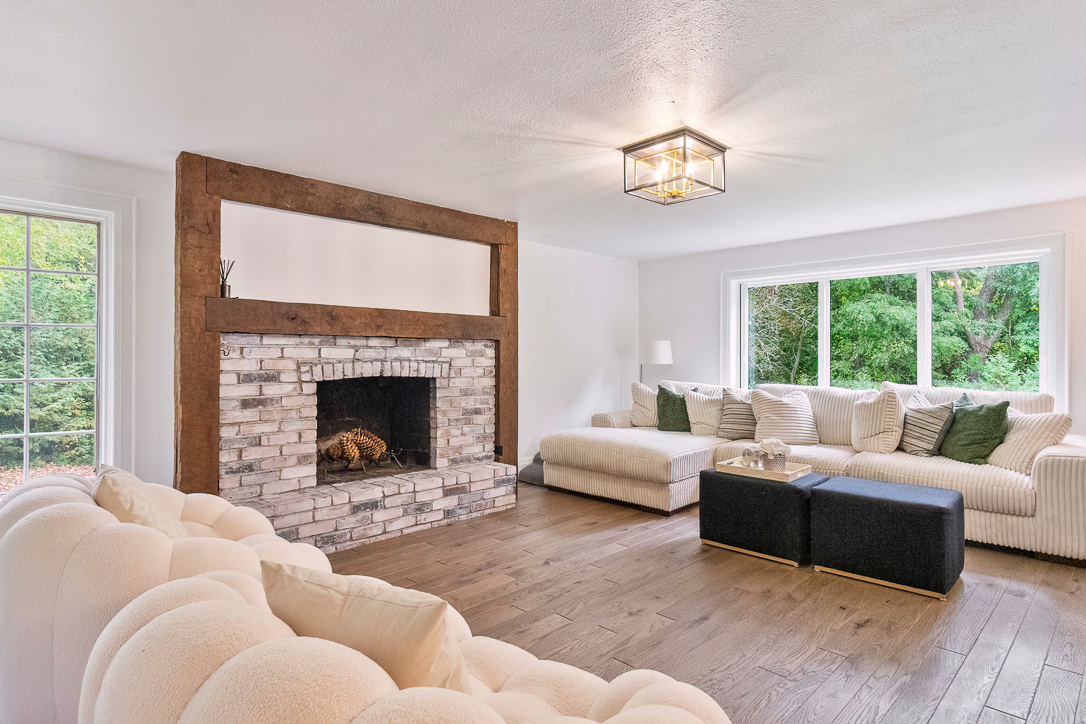 Cozy living room with a stone fireplace and large windows