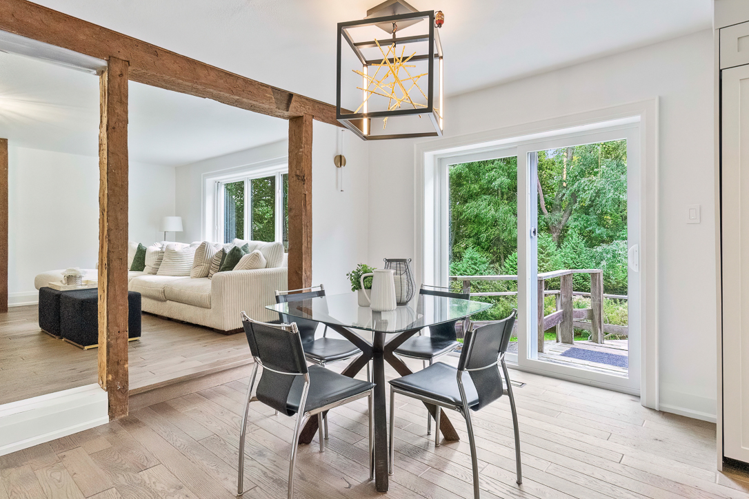 Modern dining area with a glass table and wooden accents
