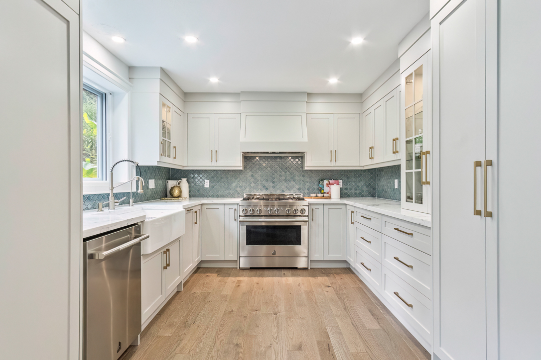 Modern kitchen with white cabinetry and stainless steel appliances