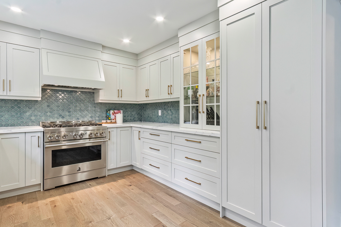 Modern kitchen with white cabinetry and stainless steel appliances
