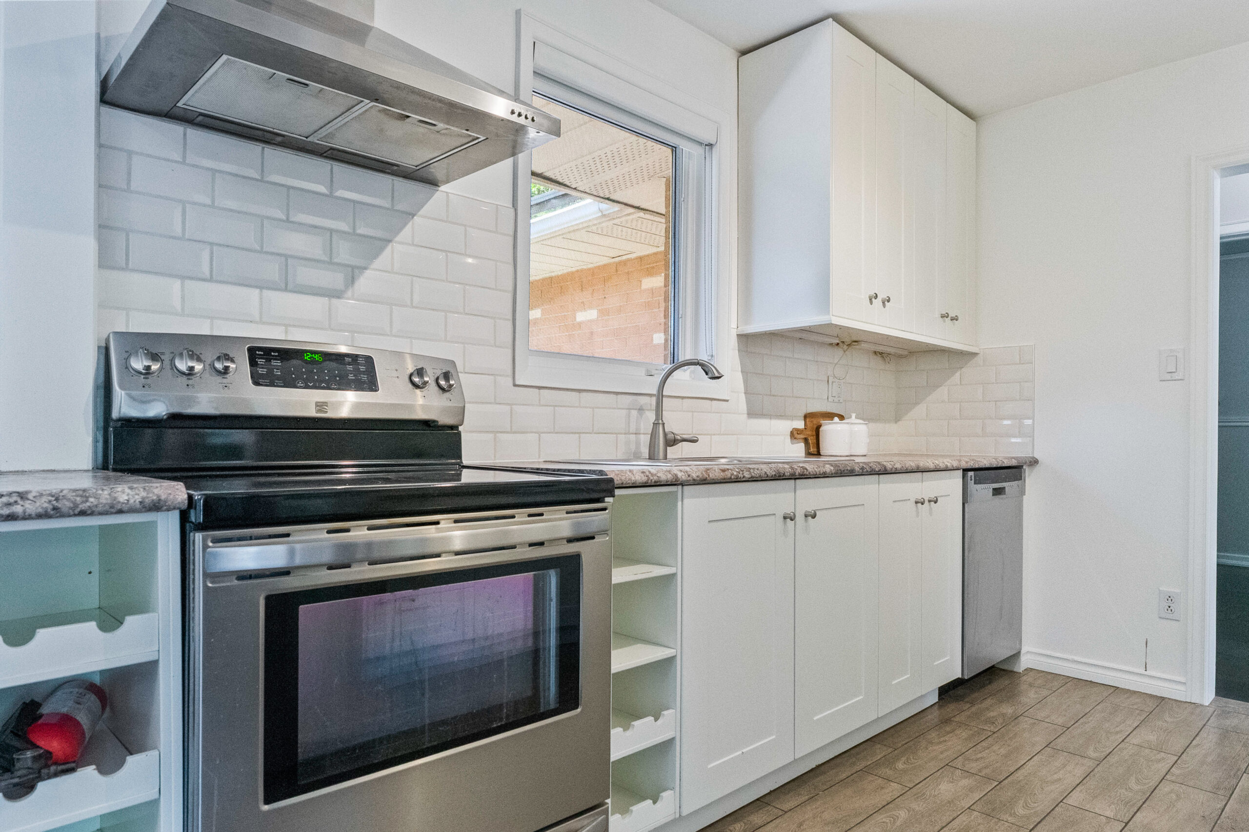 Modern kitchen with stainless steel appliances and white cabinetry