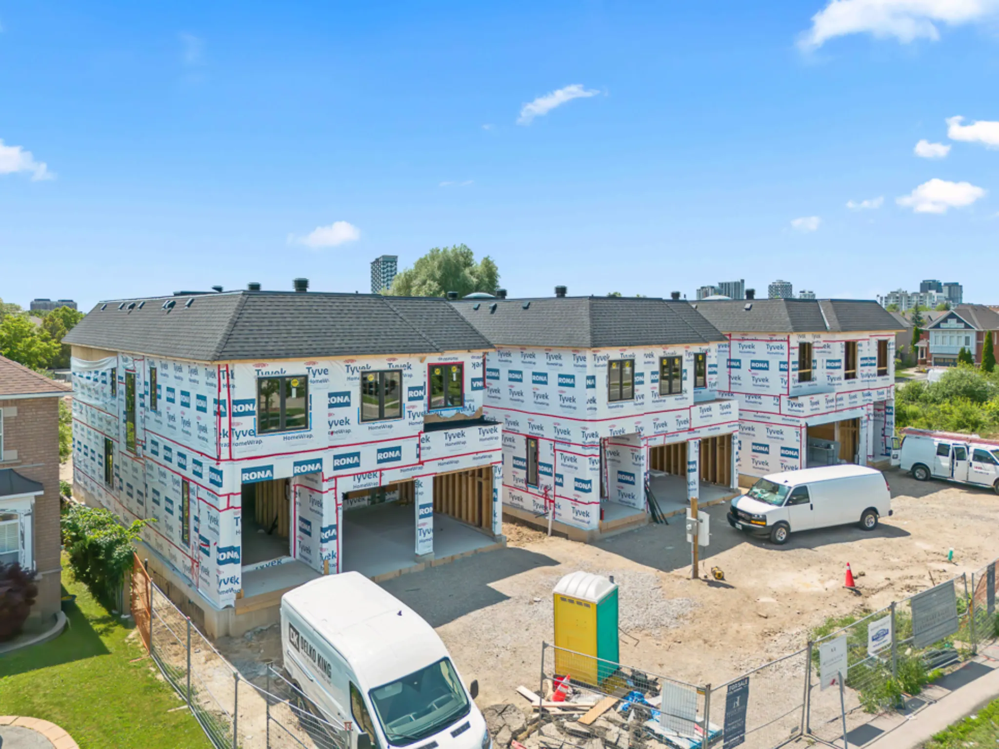 full view of the three new homes that are under construction