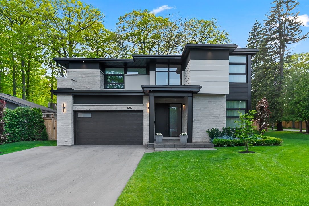 Modern two-story house with a landscaped yard and driveway