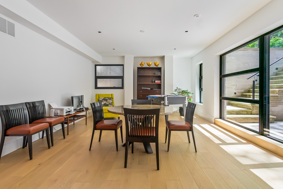 Modern dining area with wooden floor and large windows