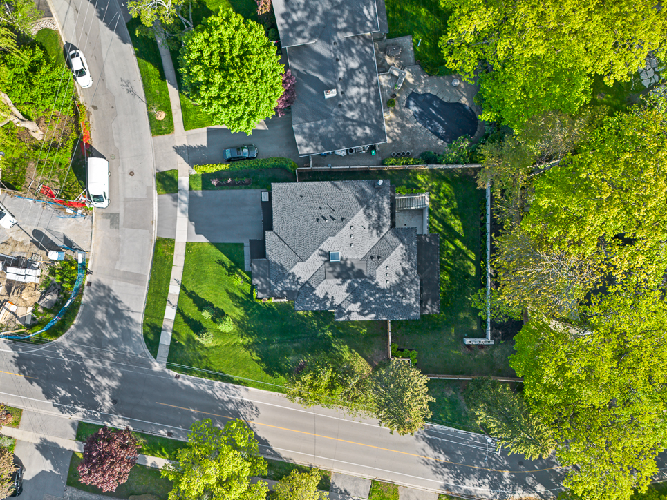 Aerial view of a residential neighborhood with green trees and houses