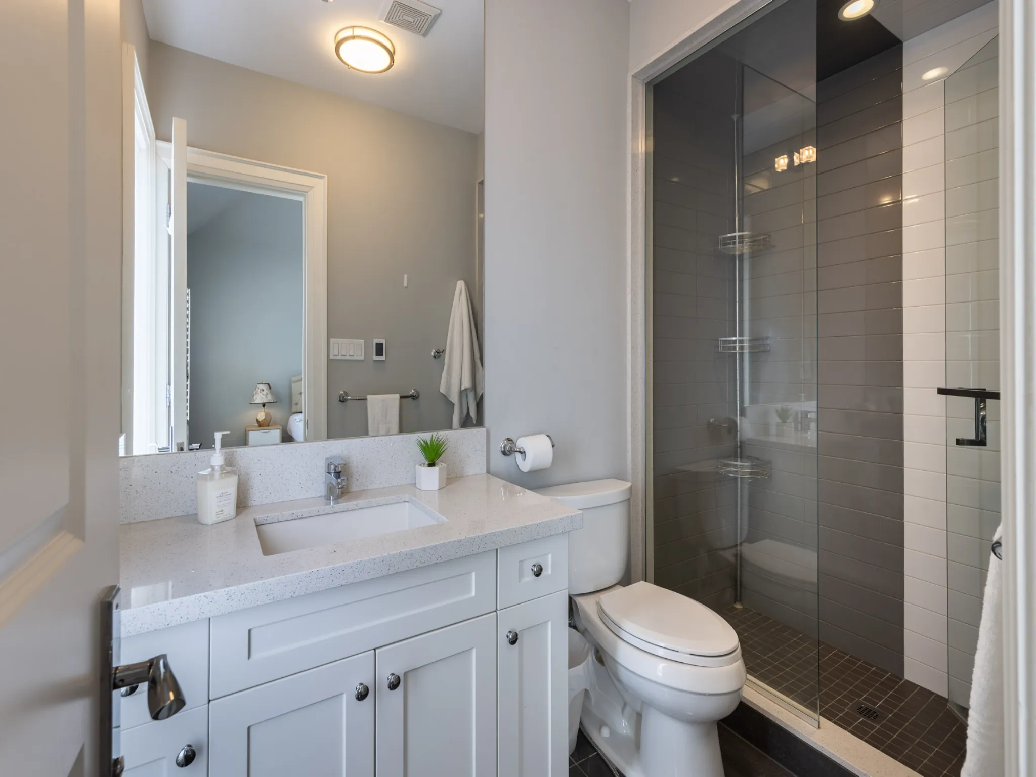 bathroom with white vanity, toilet and glass shower