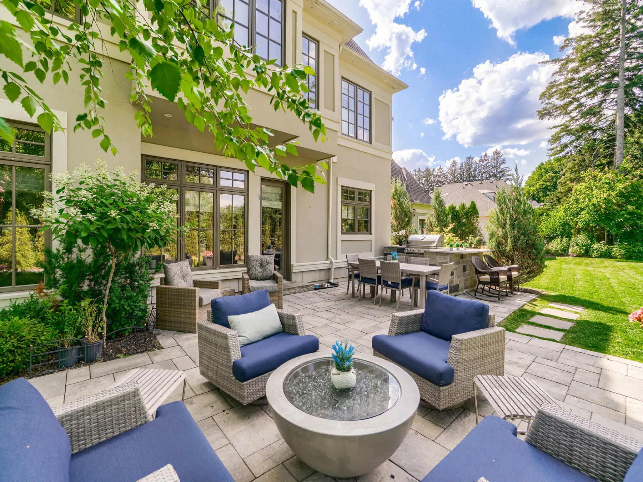 exterior of the home with patio and fantastic conversation area with club chairs
