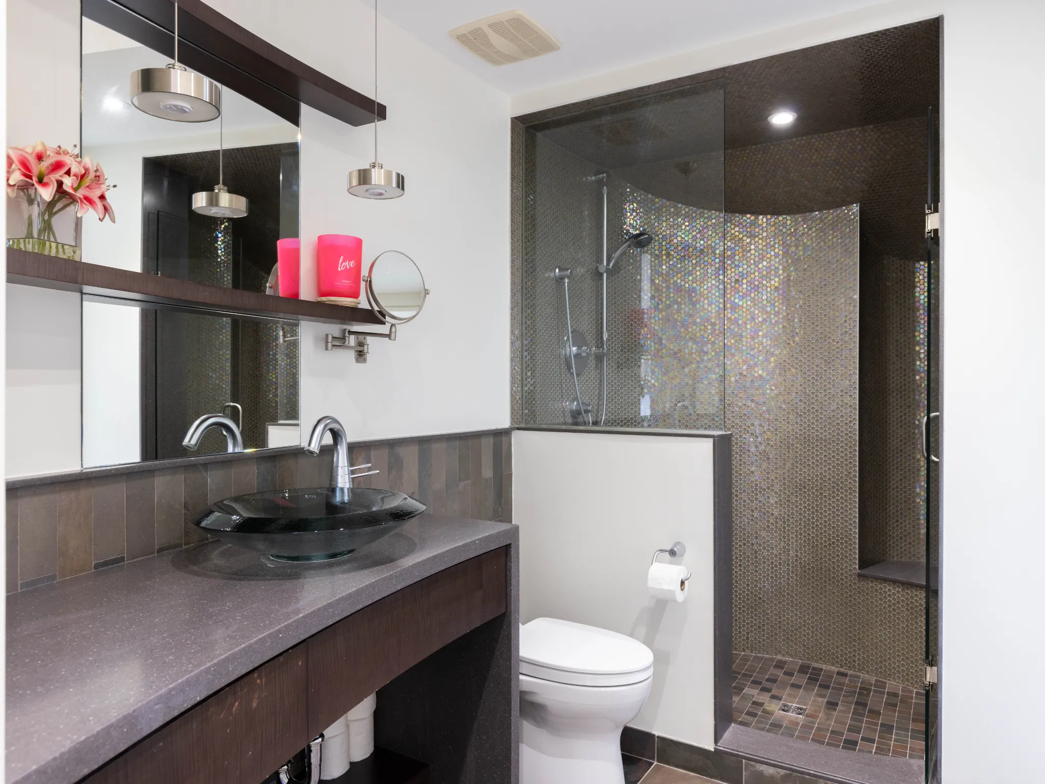 lower level bathroom with large vanity and glassed in shower