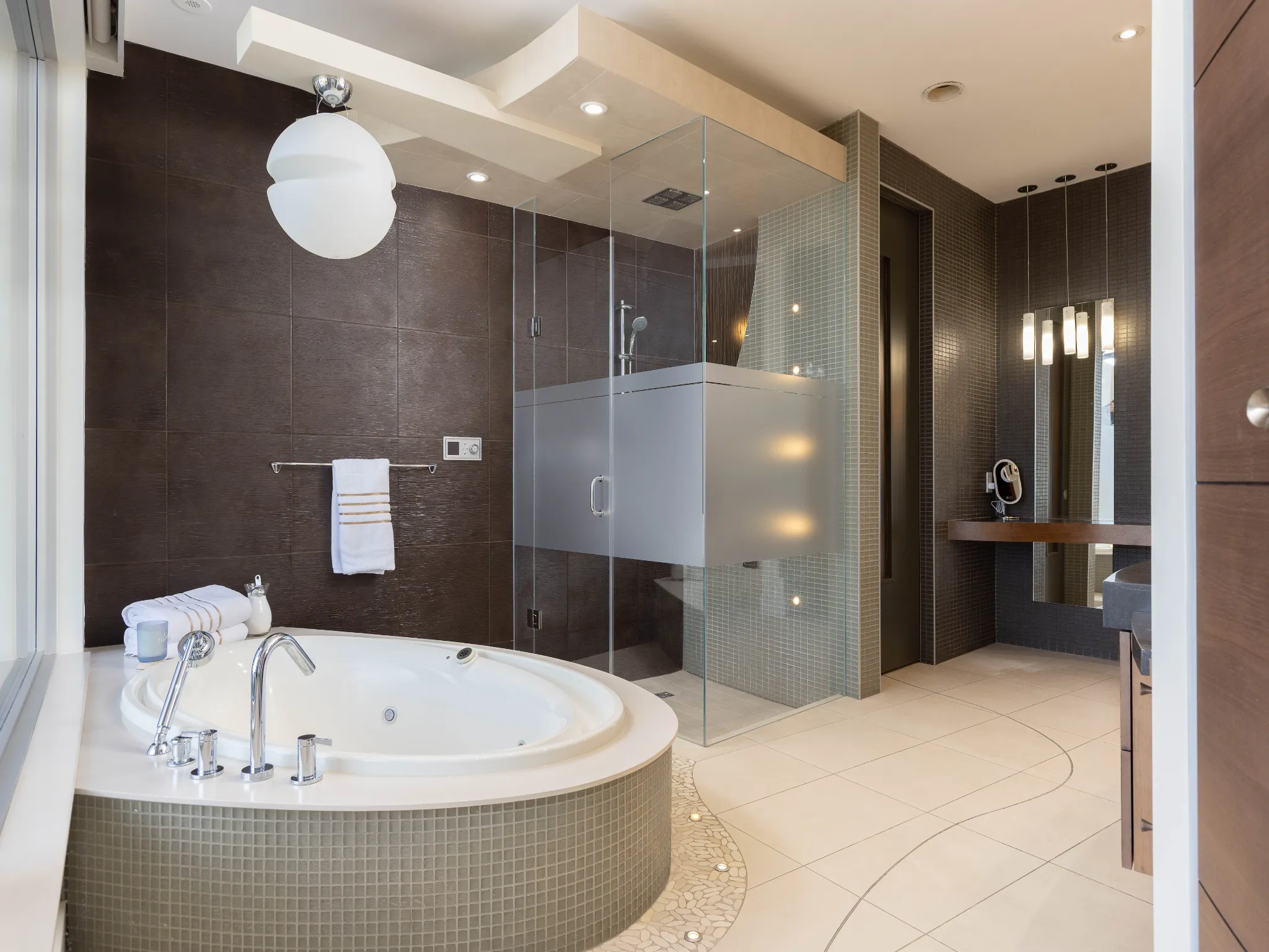 large soaker tub with glassed in shower