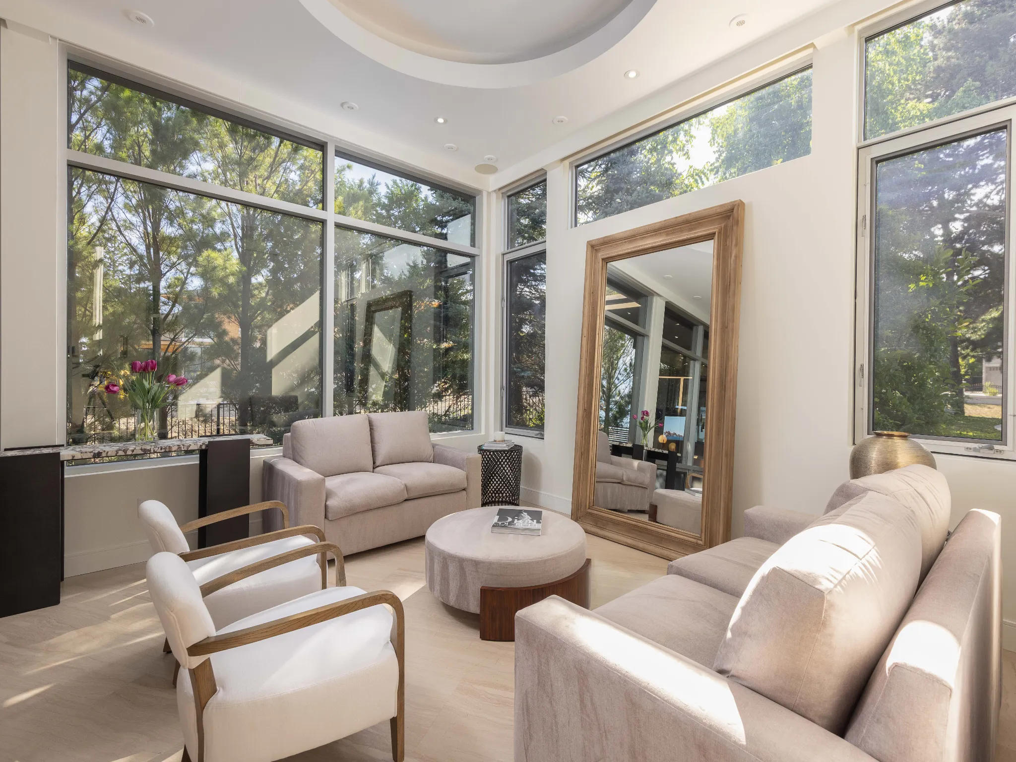 stylish living space with lots of seating and a large floor mirror