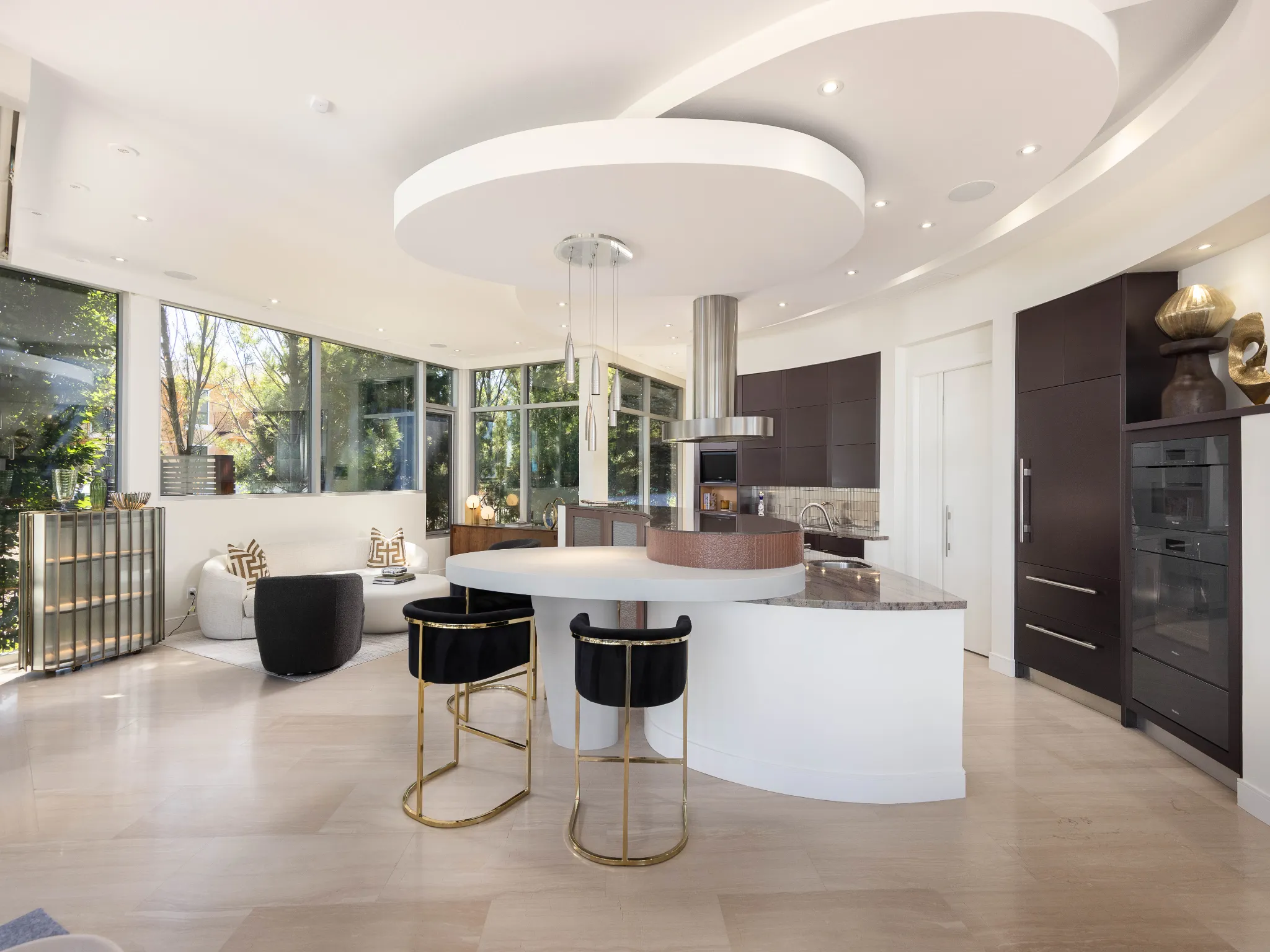 kitchen with large island and circle shapes on ceiling with recessed lighting, very modern and cool