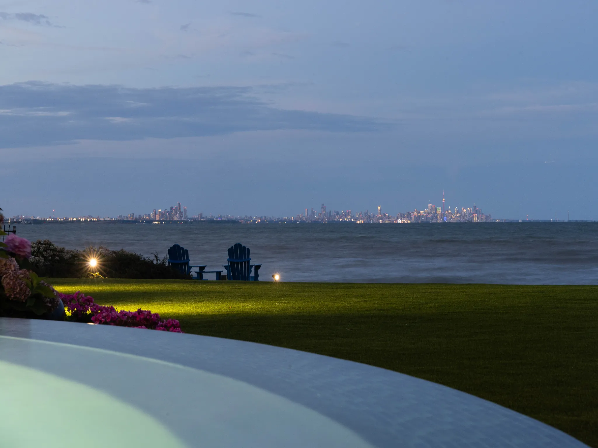 evening photo of the waterfront with city lights in the distance