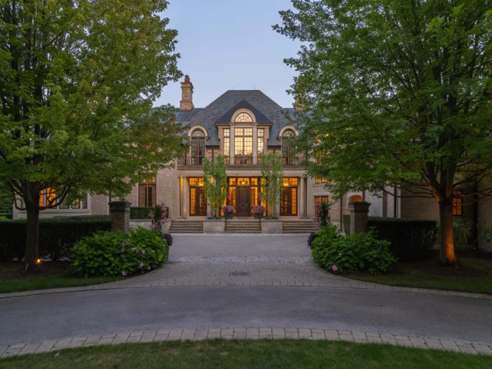 exterior of the home during the evening with lights warming glowing from within