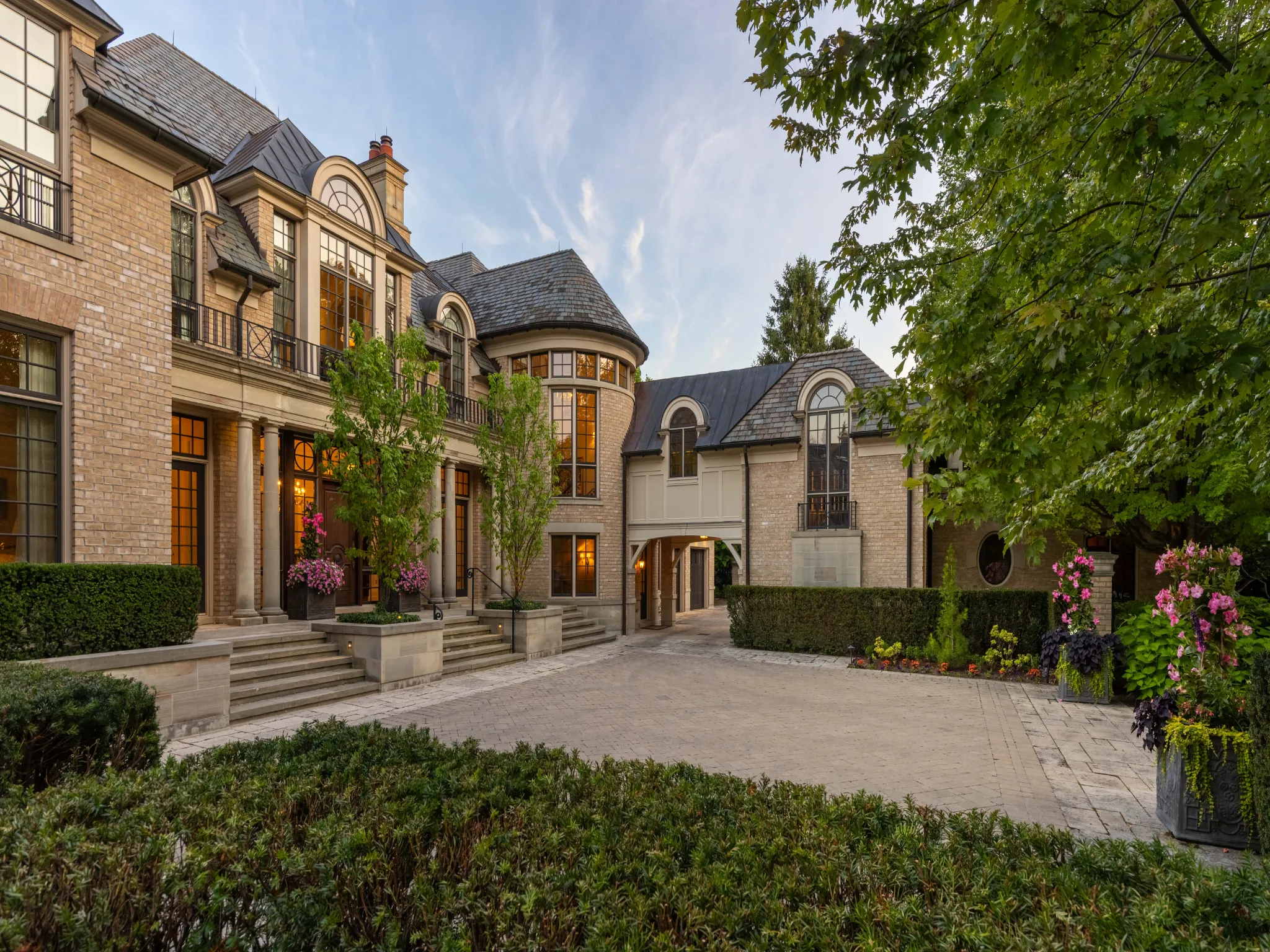 exterior showing garage, extensive parking and front door