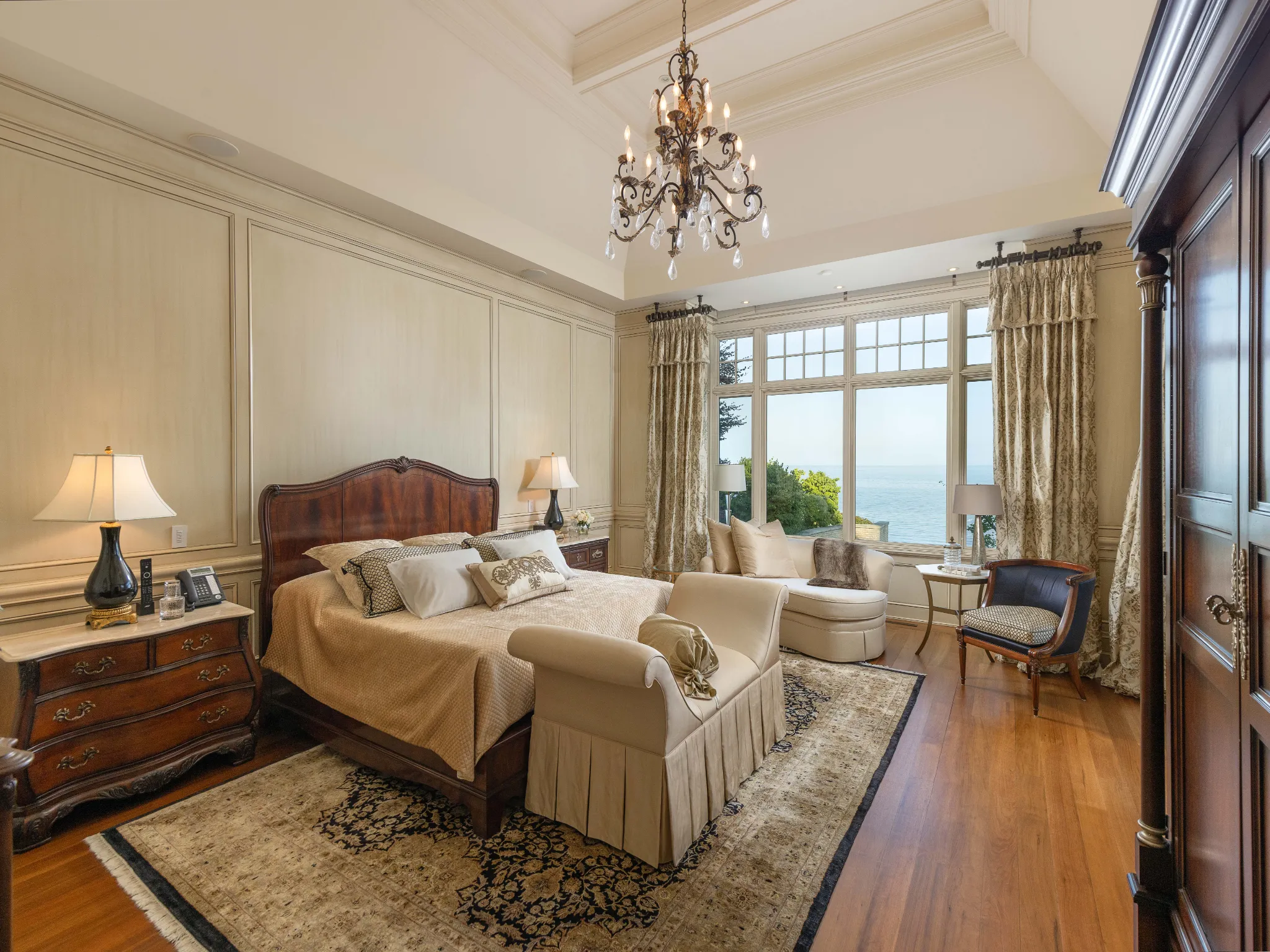 principal bedroom with vaulted ceilings and wood bed