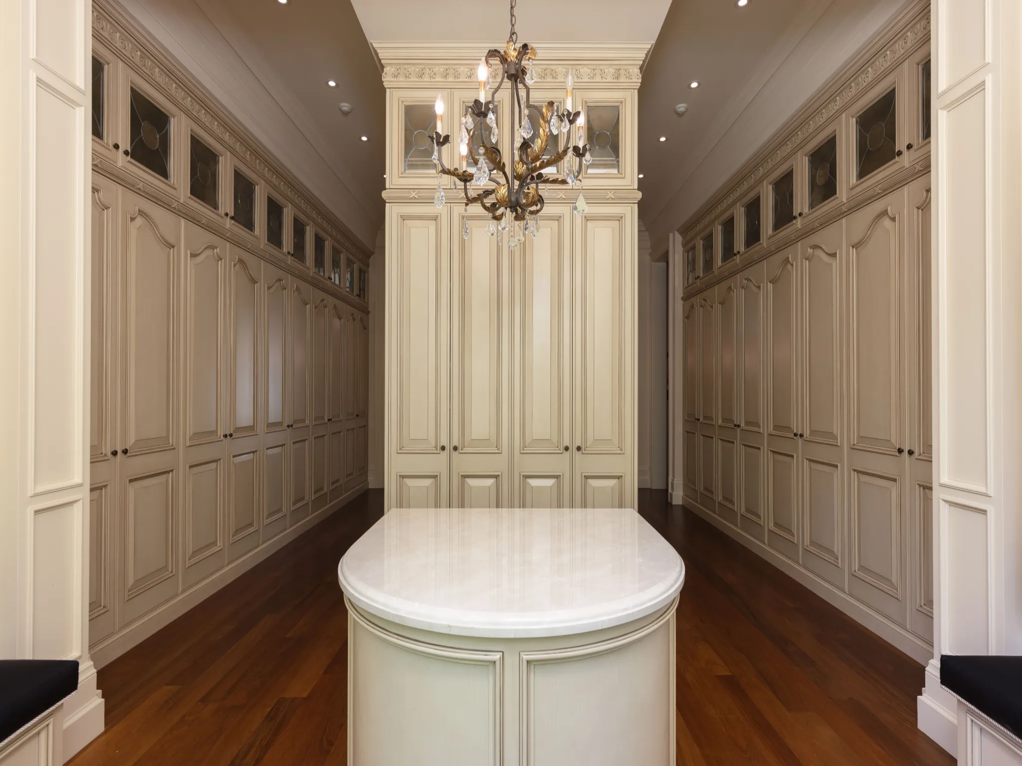 principal walk in closet with chandelier and lots of closet space