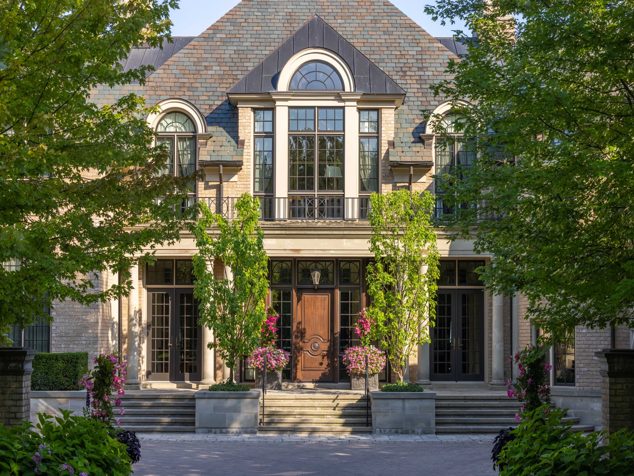 front exterior of the house mid afternoon trees casting shadows