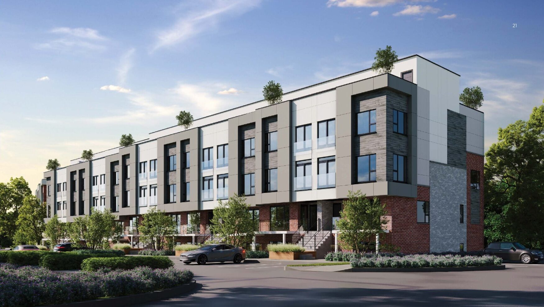 Modern multi-unit residential building with greenery and blue sky