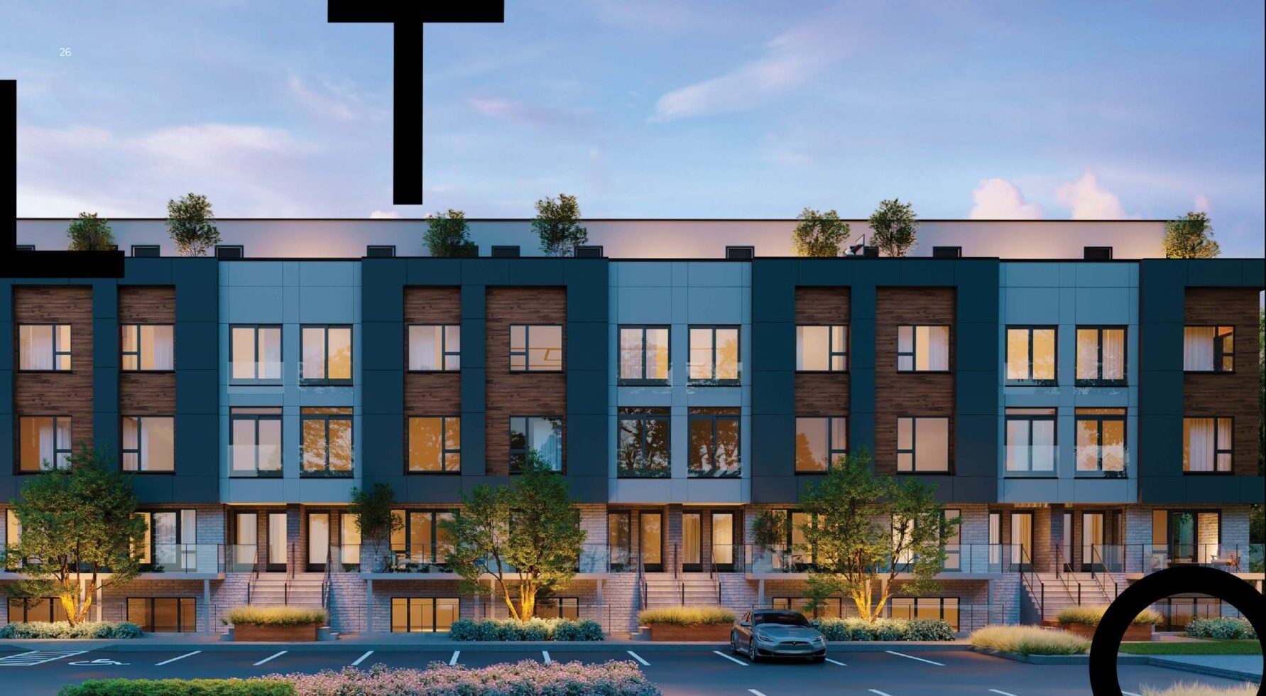 Modern townhouses with large windows and greenery at dusk