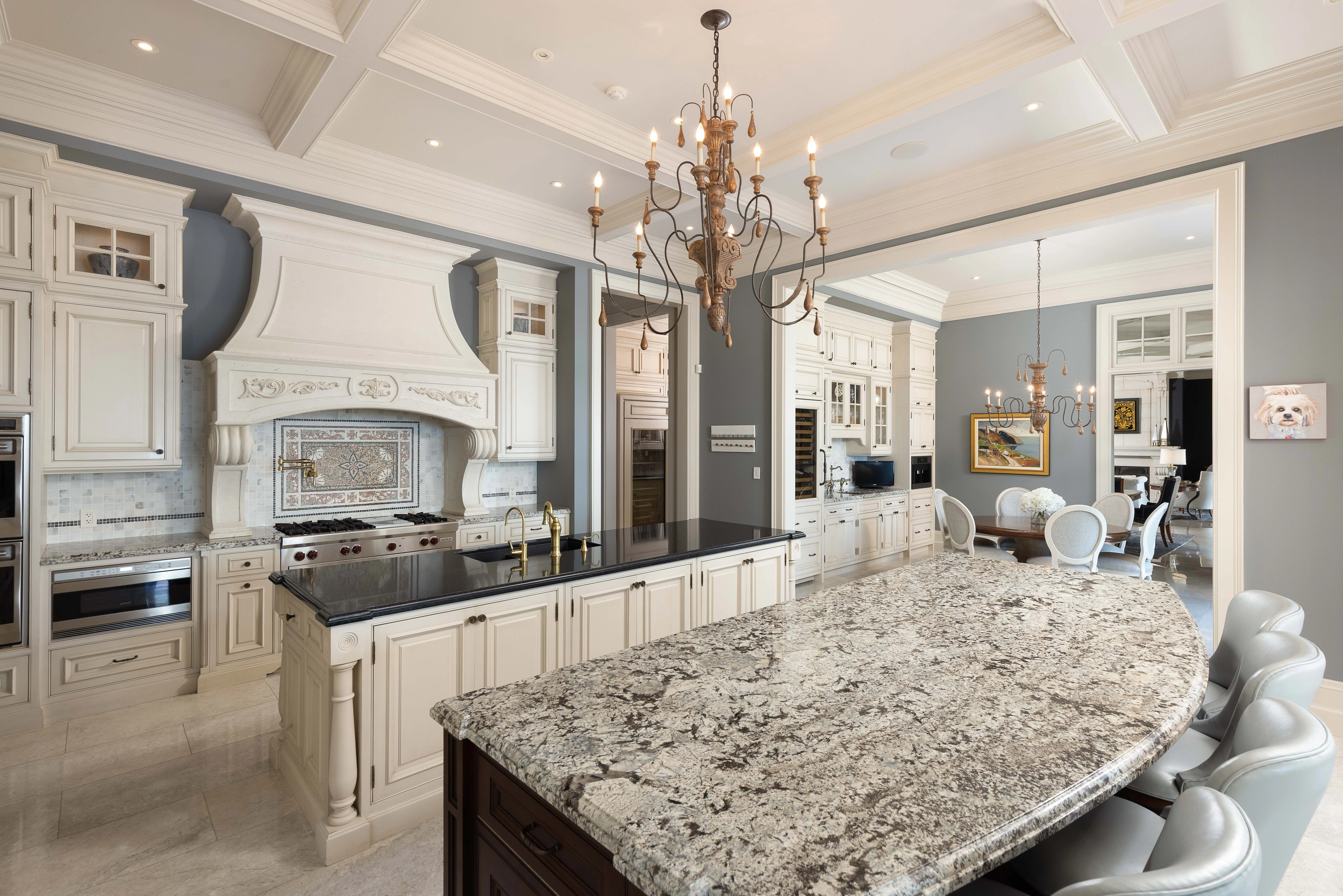 kitchen with granite countertops and luxurious large chandelier