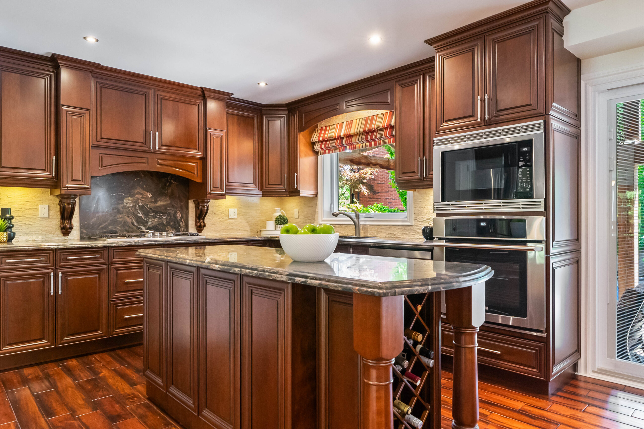 Modern kitchen with dark wood cabinets and granite countertops