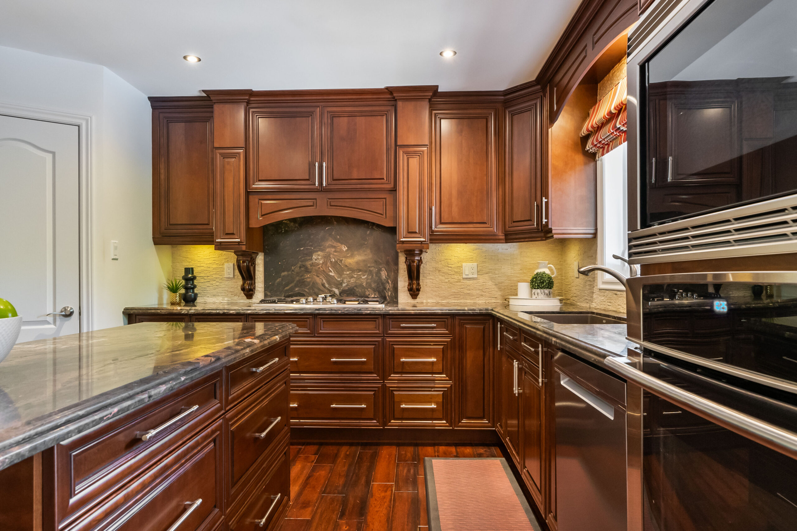 Elegant kitchen with dark wood cabinets and granite countertops