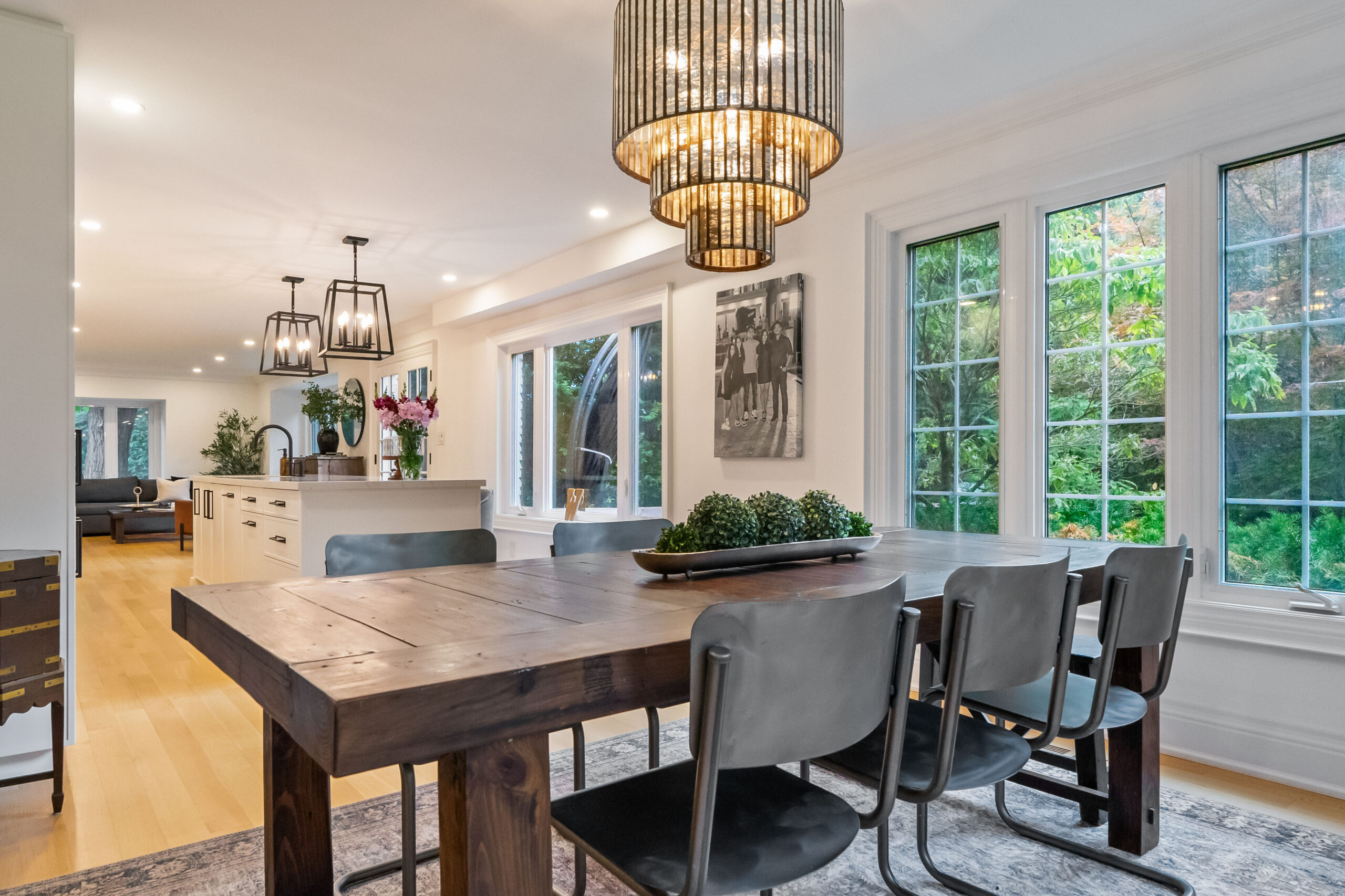 Modern dining area with a wooden table, stylish chairs, and large windows.