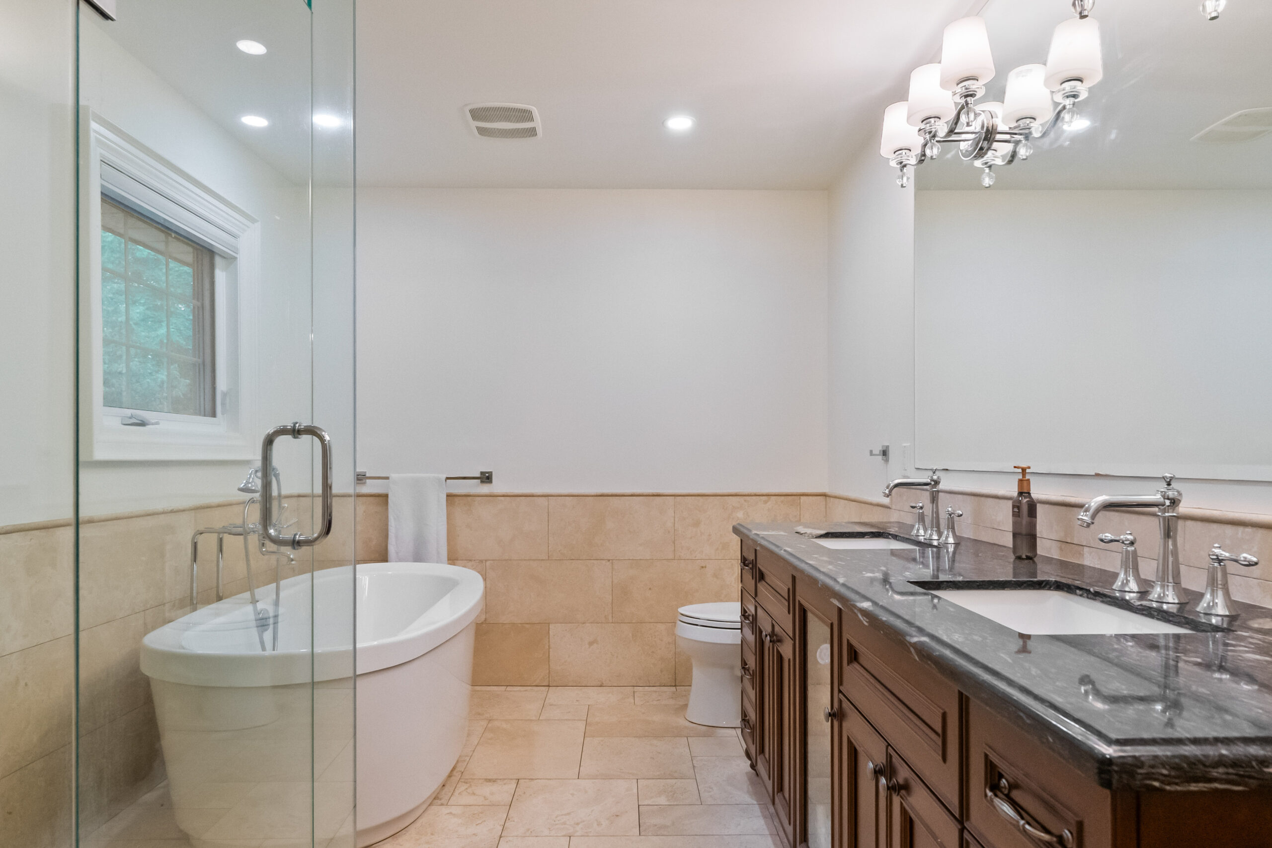 Modern bathroom featuring a freestanding tub and double vanity.