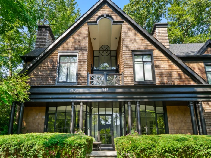 Elegant two-story house with a gabled roof and large windows