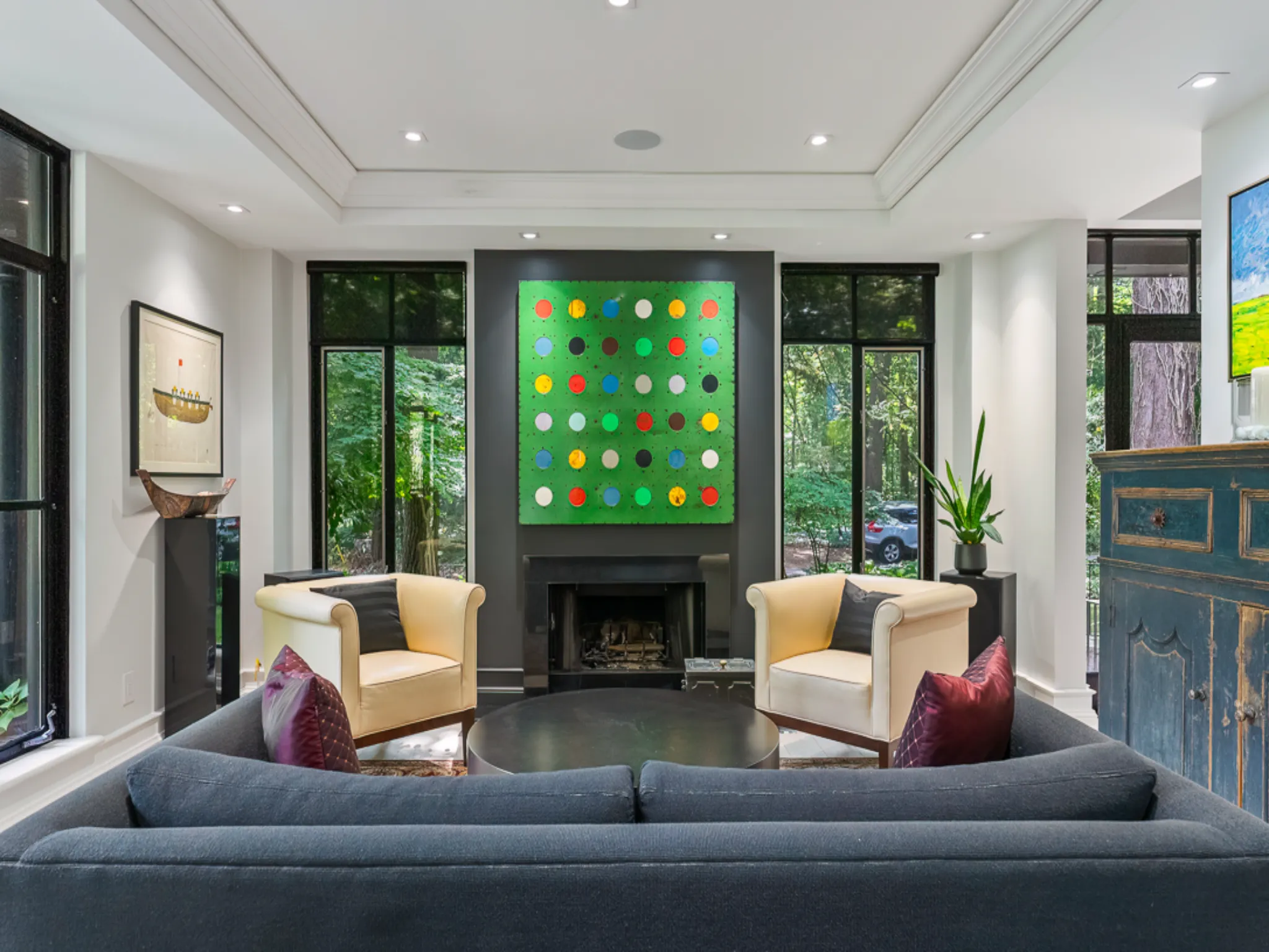 Modern living room with a colorful wall art and cozy seating.